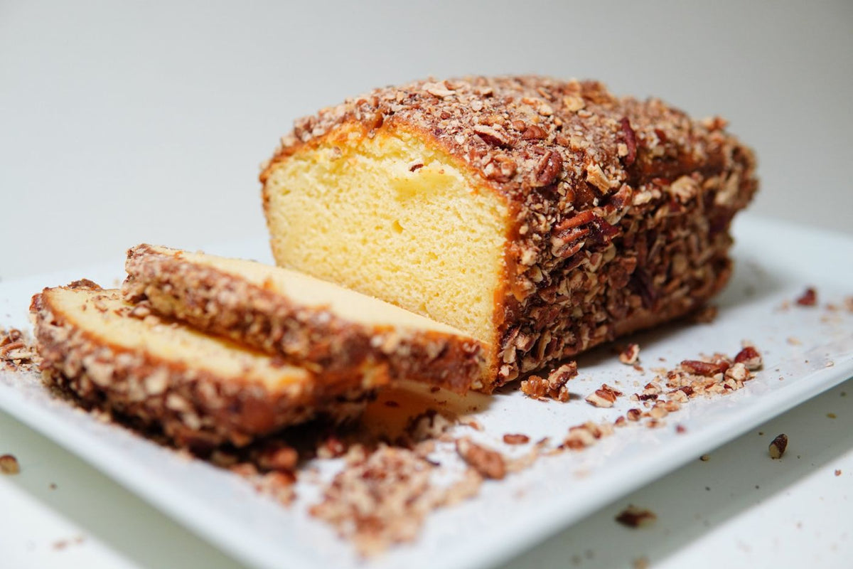 Caramel Pecan Butter Pound cake coated in chopped pecans, sliced